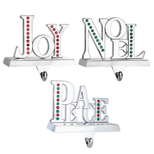 Load image into Gallery viewer, Stocking Holder Set of 3 - Joy Noel Peace Christmas Stocking Hanger for Mantel - Shiny Silver Metal Christmas Stocking Holder for Fireplace Mantle- Heavy Stocking Holder for Mantle with Hook By Klikel